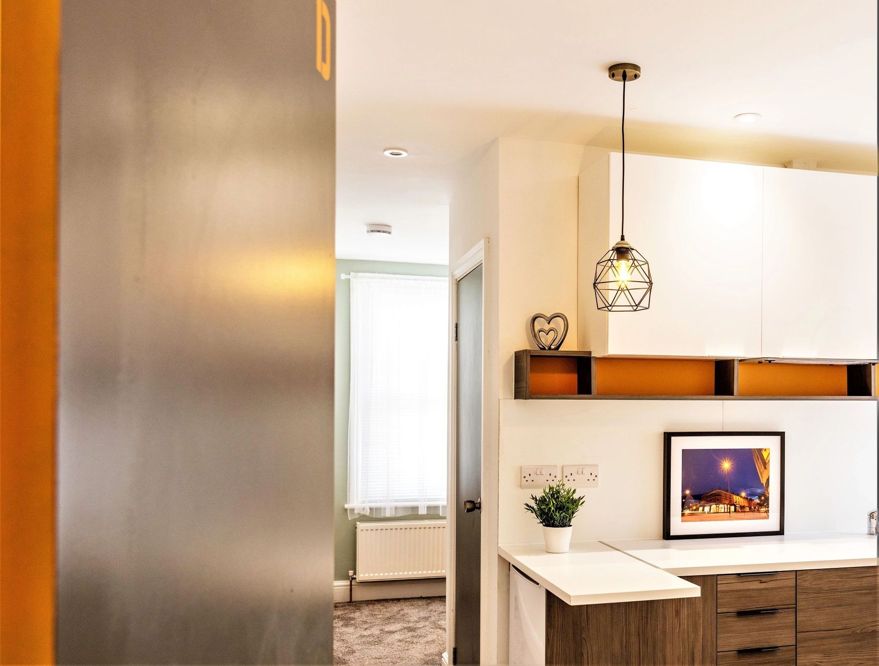 Looking through to a bright kitchen and bedroom at Groundwell 2, after renovation